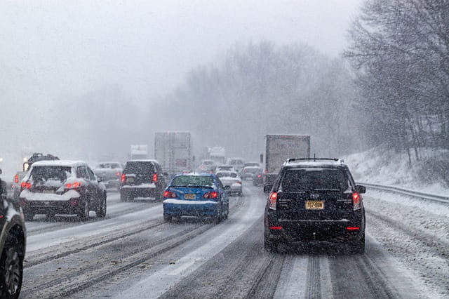 Winter snowfall on busy highway
